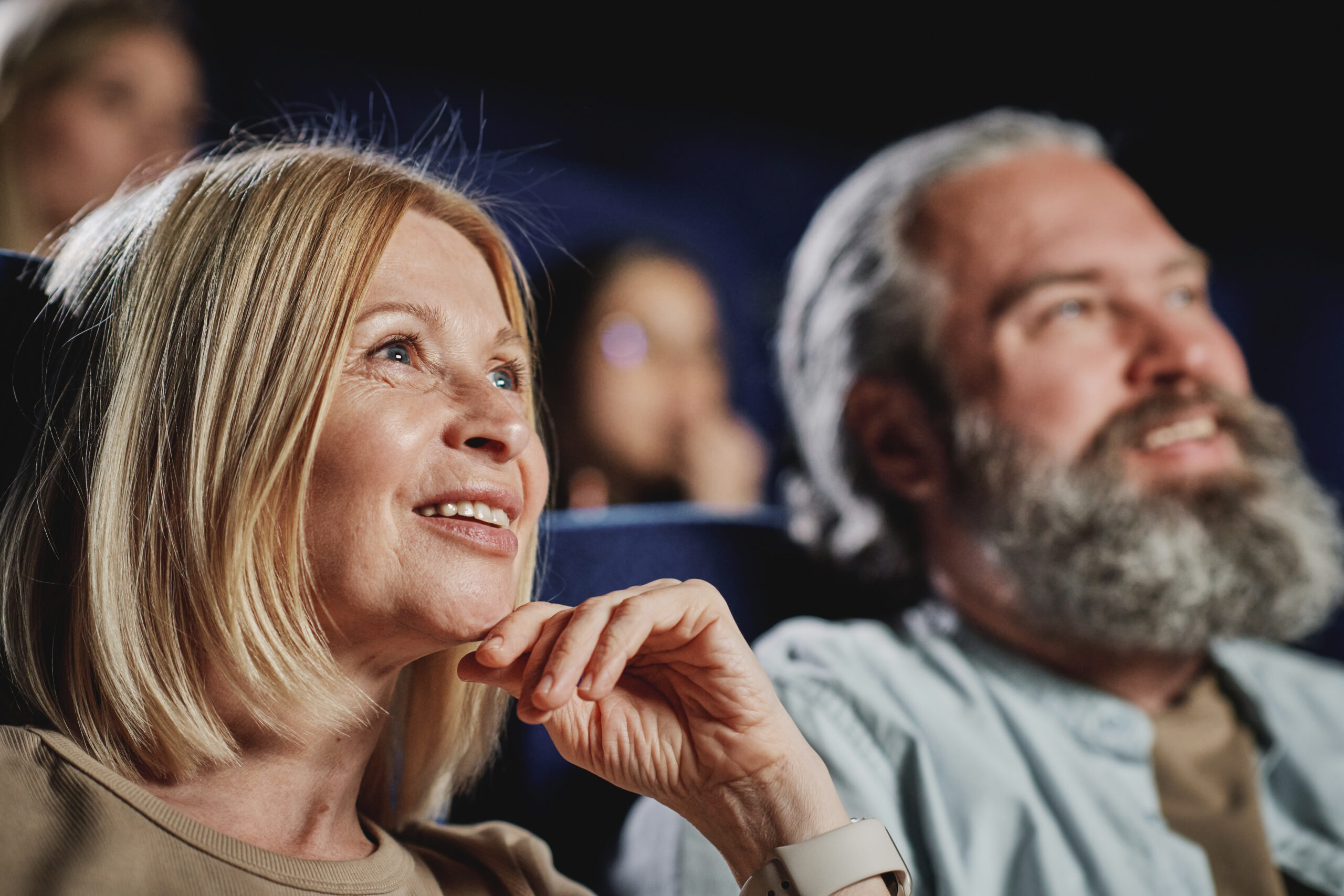 Couple sitting in audience and smiling