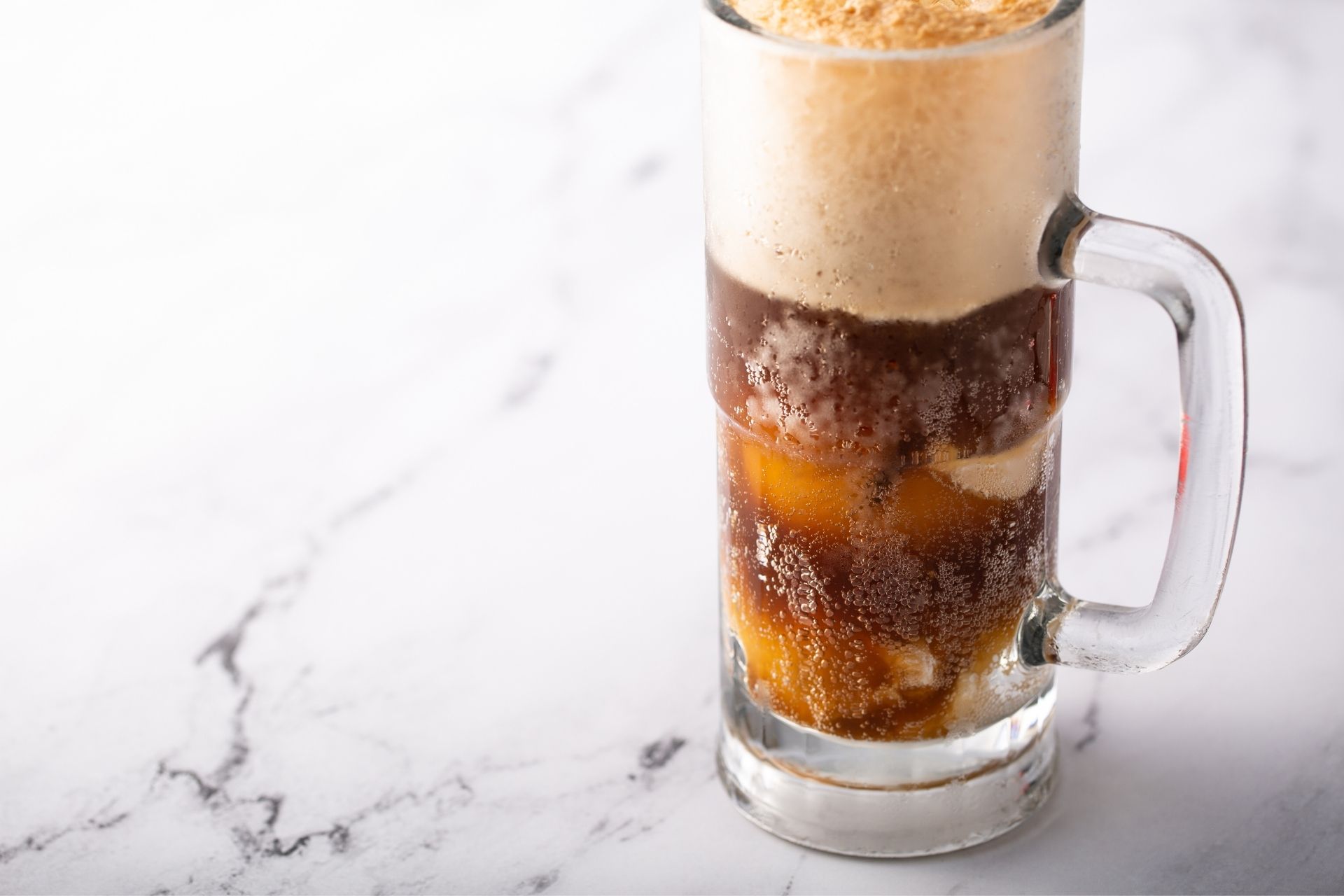 a glass of root beer with a scoop of ice cream on the top.
